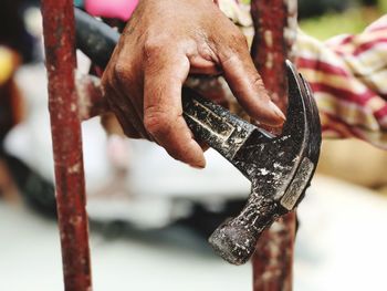 Close-up of hand holding hammer