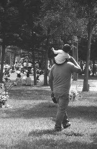 Rear view of couple walking in park