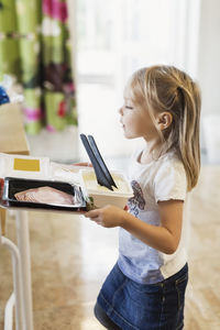 Girl carrying food in tray at preschool