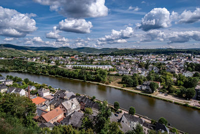 High angle view of townscape by river against sky