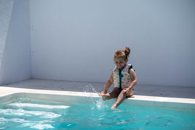 Side view of girl playing in pool