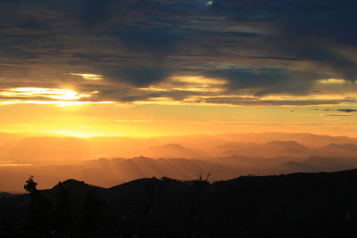 Scenic view of silhouette mountains against sky during sunset