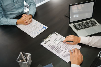 Midsection of business colleagues working at office