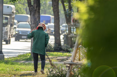 Rear view of man standing against trees