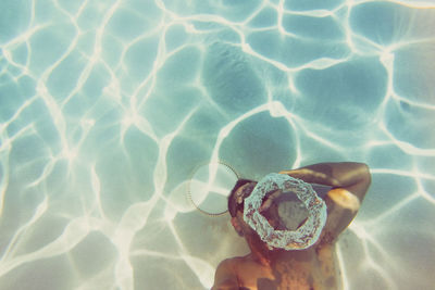 High angle view of hand on swimming pool