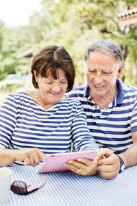 Mature couple using digital tablet