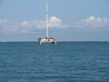 Sailboat sailing on sea against sky