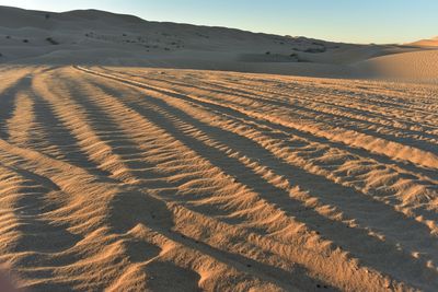 Scenic view of desert against sky during sunset