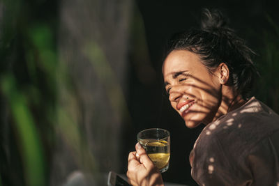 Portrait of a young man drinking glass