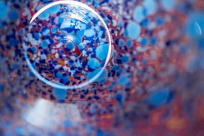 High angle view of multi colored ball on glass table