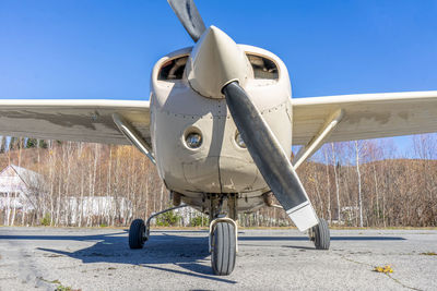 Low angle view of airplane against clear blue sky