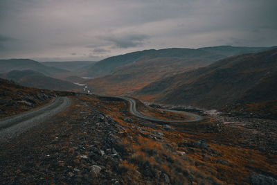 Aerial view of mountain road against cloudy sky