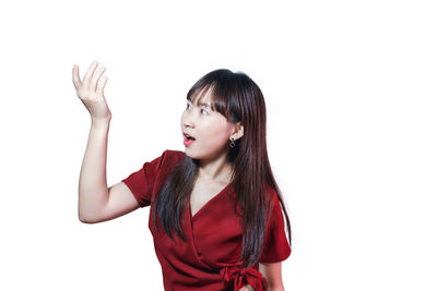 Portrait of beautiful young woman against white background