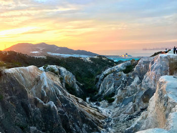 Scenic view of rocky mountains against sky during sunset