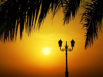 Low angle view of street light against sky during sunset