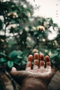 Close-up of hand on wet glass