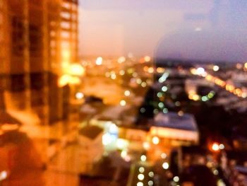 Defocused image of illuminated city at night