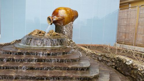 Water flowing from urn at fountain
