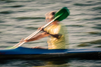 Man holding boat in sea