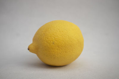 Close-up of yellow lemon on table