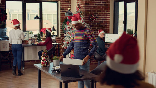 Rear view of woman holding christmas presents