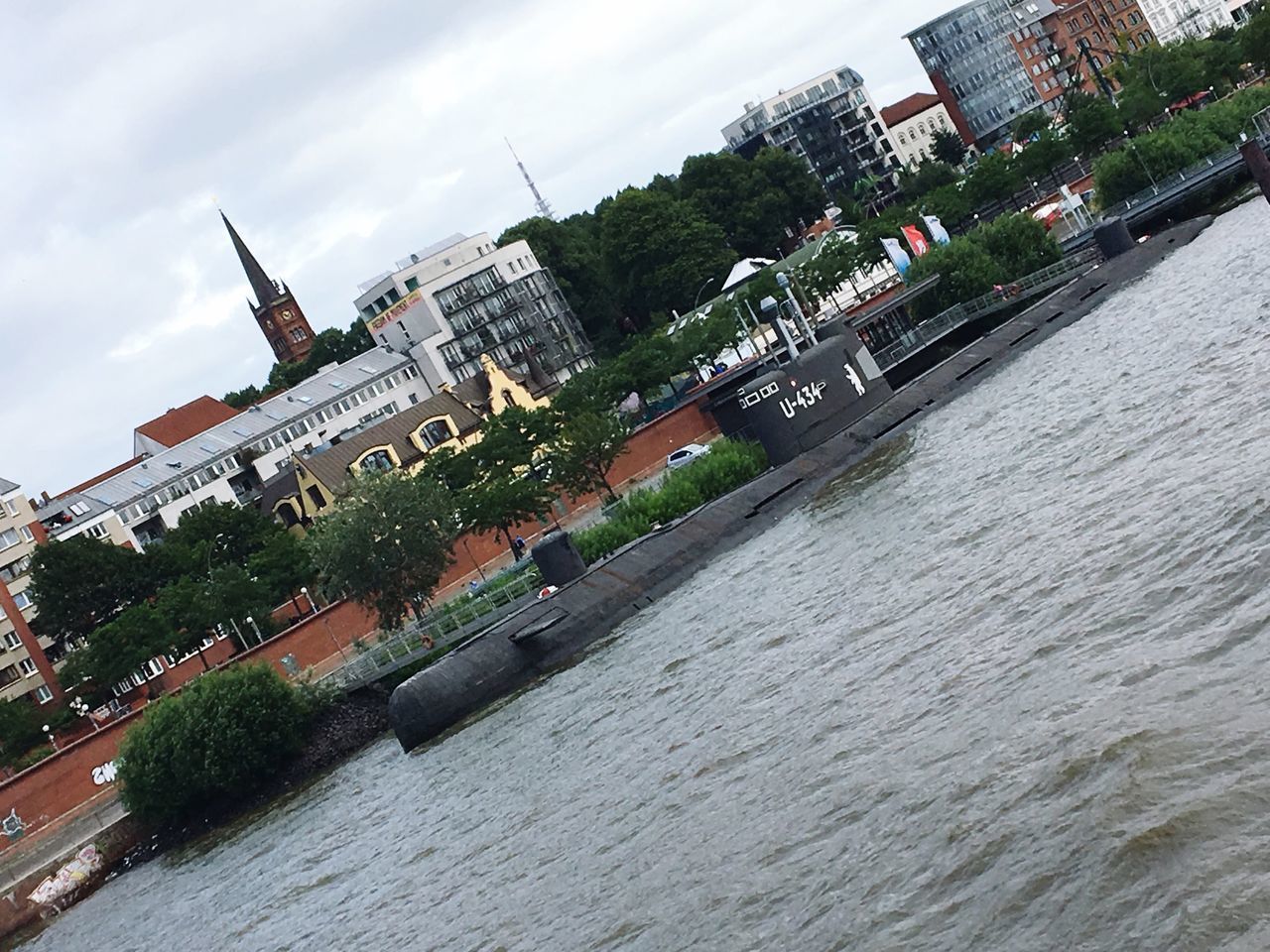 PANORAMIC VIEW OF RIVER AMIDST BUILDINGS IN CITY