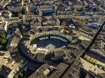 Aerial view of piazza dell'anfiteatro, a medieval square in lucca old town, tuscany, italy.