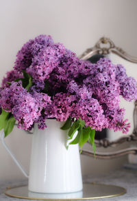 Close-up of purple roses in vase on table