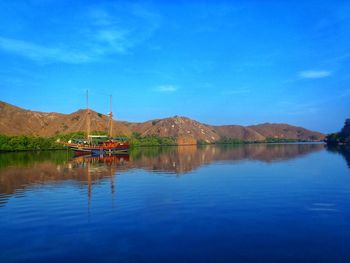 Scenic view of lake against blue sky