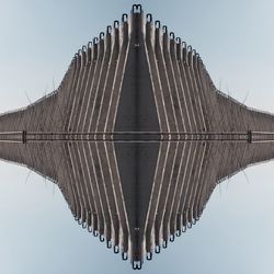 Building reflecting on calm lake against clear sky