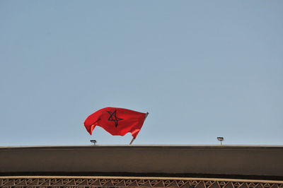 Low angle view of flag against clear sky
