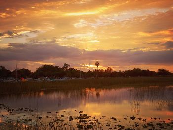 Scenic view of lake against orange sky