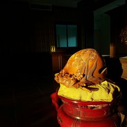 Close-up of illuminated statue on table at home