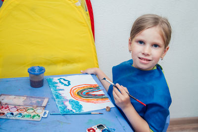 Portrait of smiling boy on table