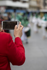 Midsection of man using mobile phone