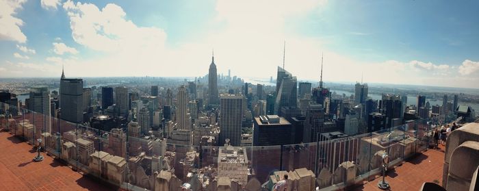 Cityscape against cloudy sky