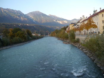 Scenic view of river amidst mountains against clear sky