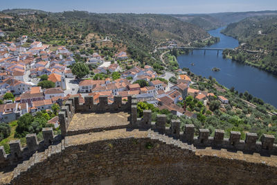 High angle view of townscape by river in city