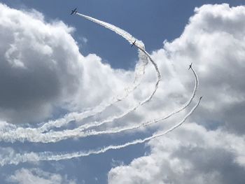Low angle view of airshow against sky