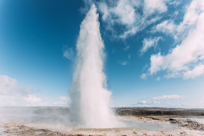 View of geyser against cloudy sky