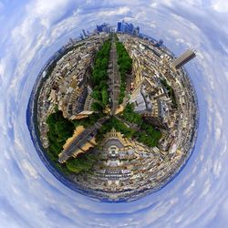 Little planet effect of cityscape against cloudy sky