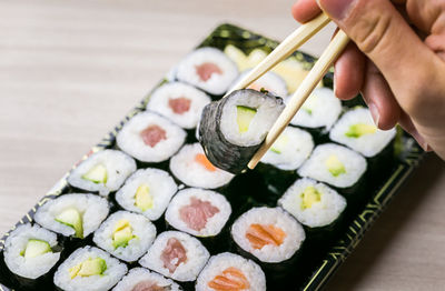 Midsection of person holding sushi