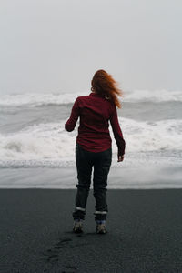 Woman on windy reynisfjara black beach scenic photography