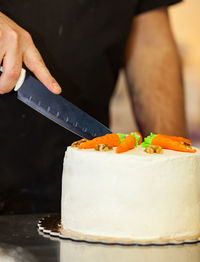 Carrot cake with cream cheese frosting and little carrots on top