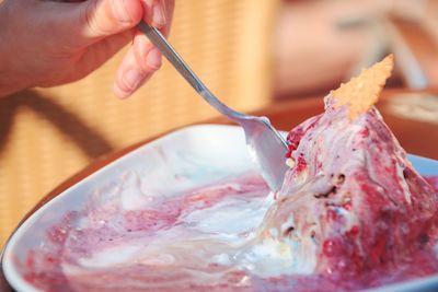 Close-up of hand holding ice cream