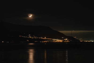 Scenic view of illuminated mountains against sky at night