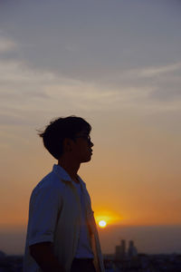 Silhouette man standing against sky during sunset