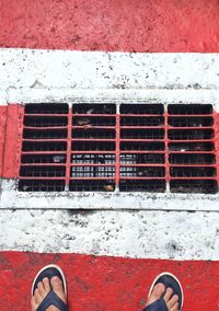 Low section of person standing on red floor