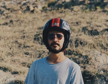 Portrait of young man standing on land