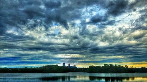 Scenic view of calm lake against cloudy sky